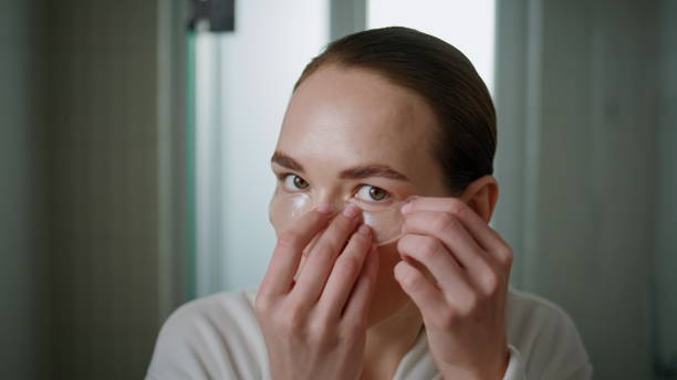 istock Model using eyes patches in bathroom closeup. Delicate daily beauty routine. 2177452971