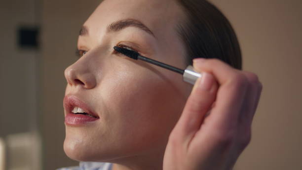 istock Closeup girl using mascara at home. Attractive model applying makeup in evening 2177454130