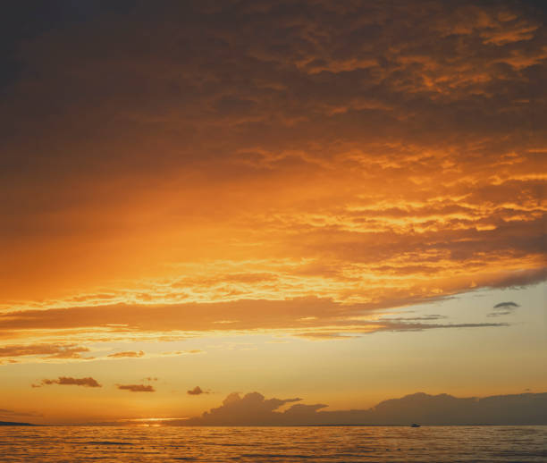 istock Scenic view of calm bay and clouds at sunset 2177455375