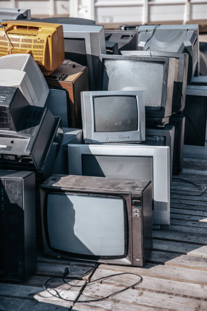 Heap of electronical appliances waste, monitors and tv-s stock photo