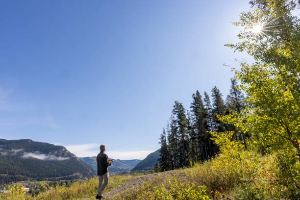 istock Mature man hikes along mountain path 2177466666