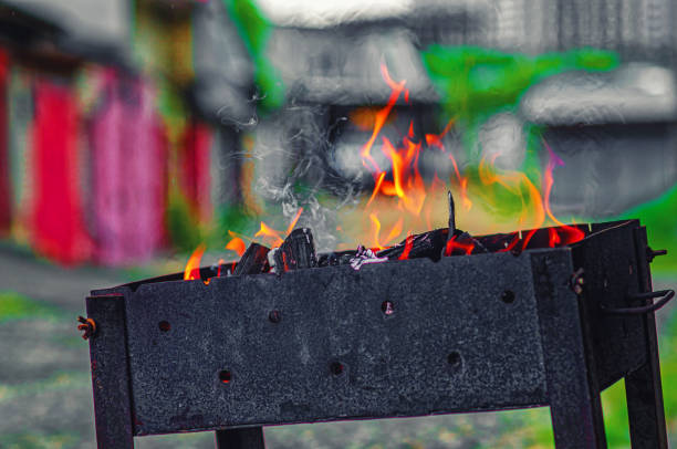Hearth in a metal brazier. Lighting a fire for cooking barbecue.