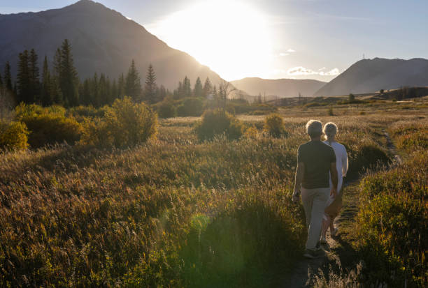 istock Mature couple explore mountain meadow at sunset 2177466875