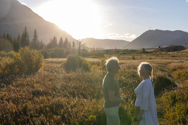 istock Mature couple explore mountain meadow at sunset 2177466878