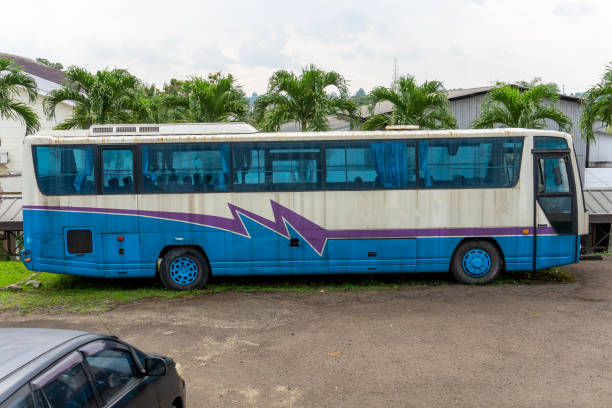 a deserted large passenger bus, left unused and weathered by time. perfect for themes of urban decay, forgotten transportation, and abandoned places