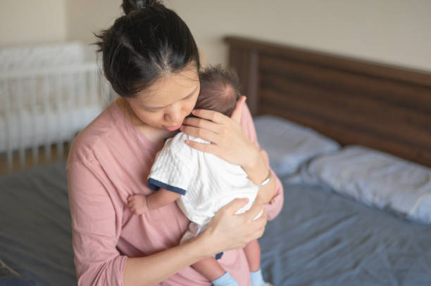 istock Mother holding infant with love in cozy home setting 2177468623