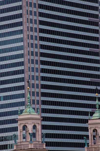old church towers and a modern office building with windows in a regular pattern