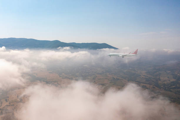 Passenger Jet airplane flying over clouds.