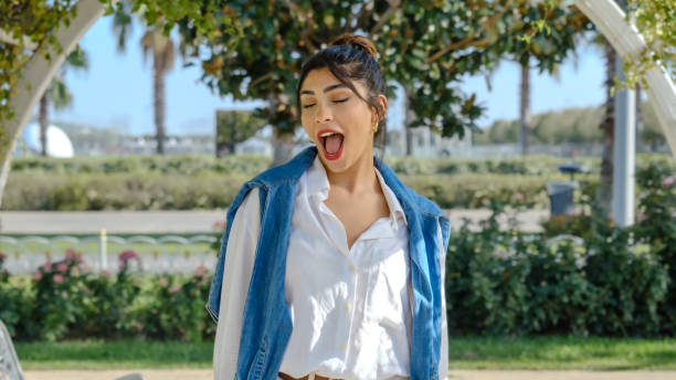 istock A young brunette businesswoman with a confused expression looking at the camera in a tree-filled park on a spring day 2177479711