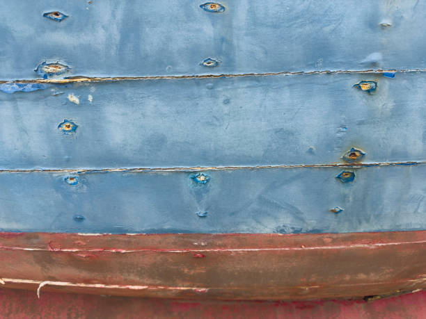 Old weathered wooden boat side with cracked paint. Close up. Abstract background.