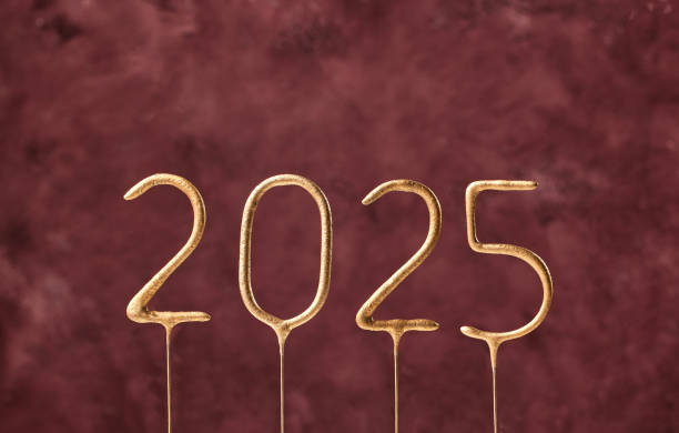istock Gold sparklers numbers 2025 isolated on dark red  background 2177483203