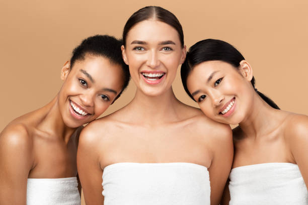 istock Three Ladies Wrapped In Bath Towels Posing On Beige Background 2177484329