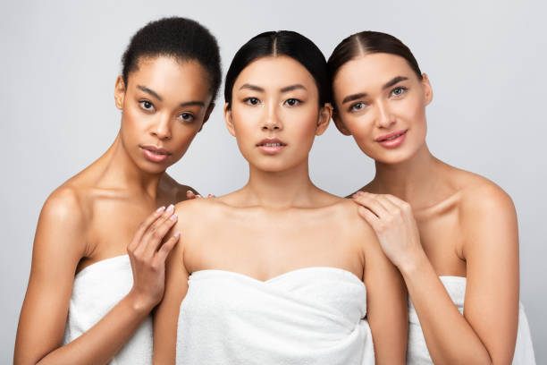 istock Three Sensual Girls Wrapped In Bath Towels Posing In Studio 2177484367