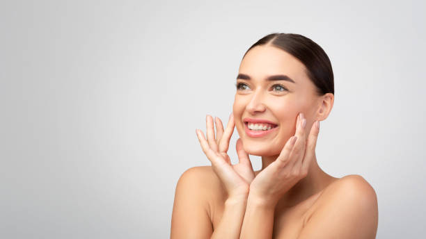 istock Woman Touching Smooth Skin Looking Aside On Light Gray Background 2177484692