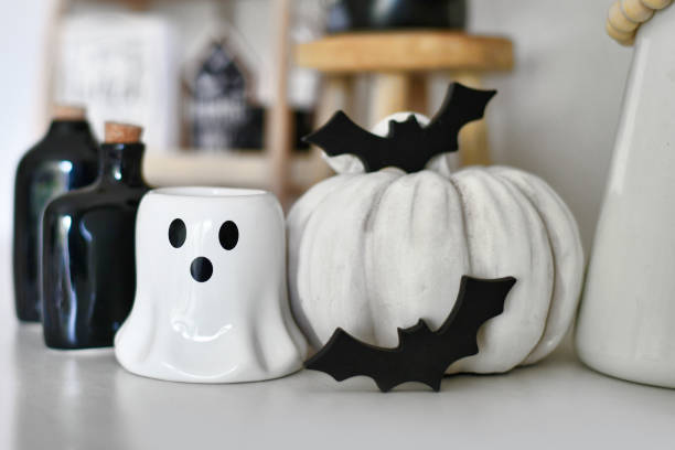 istock Halloween decoration with ghost shaped candle, pumpkin, bats and potion bottles 2177485007