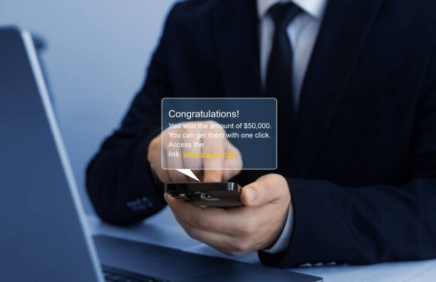 istock Businessman holding phone with scam message on digital screen. Fake text SMS scam.Scammers online.Cyber scam manipulation.Reject fakes messages.Bank fraud. 2177485072