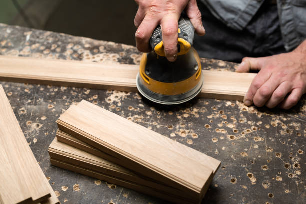 istock The carpenter grinds with a circular grinder on the desktop 2177485672