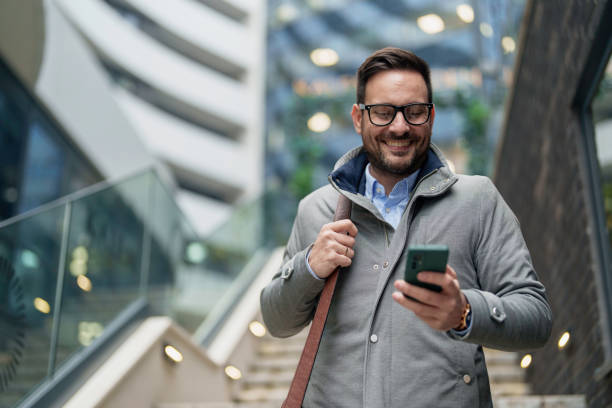 istock Professional Mid-Adult Man Texting on Smartphone 2177490012