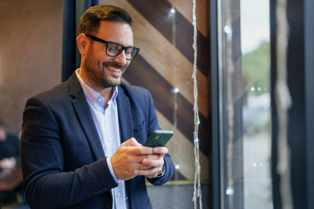 istock Professional Mid Adult Man Engaging with Smartphone in Cafe 2177490086