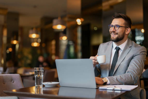 istock Professional Mid-Adult Man Working on Laptop in Cafe 2177490114