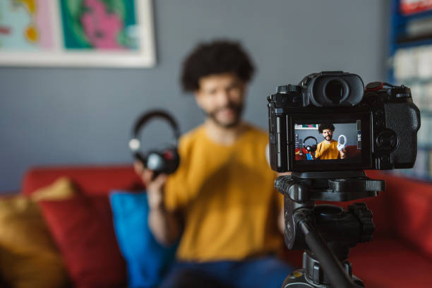 istock Hispanic man vlogger showing headphones and recording  video 2177493472