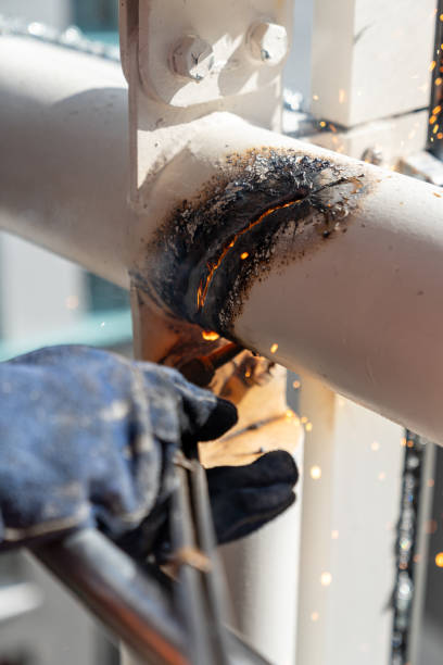 istock Construction worker welding metal pipes on building site 2177495161