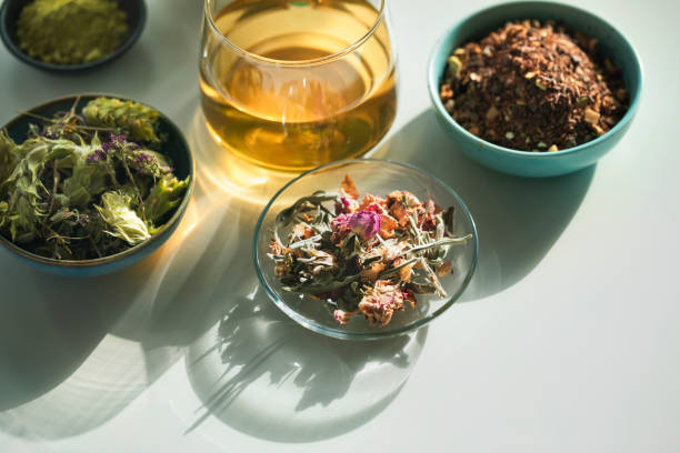 istock Herbal tea, tea cup with various dried tea leaves and flowers shot from above on white table 2177496446