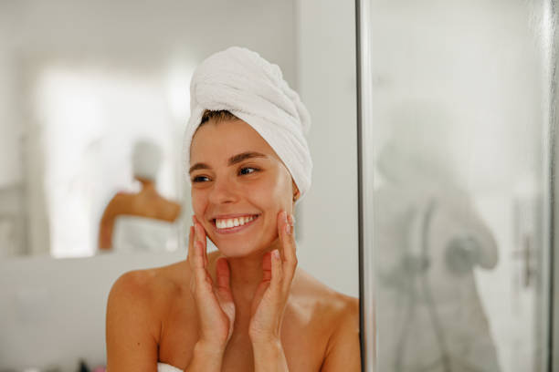 istock A Radiant Woman Enjoys Her Skincare Routine After a Refreshing Shower While Wrapped in a Towel 2177499621
