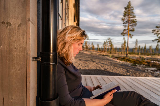 istock Woman Enjoying a Book While Relaxing Outdoors in Scenic Mountain Landscape 2177503688