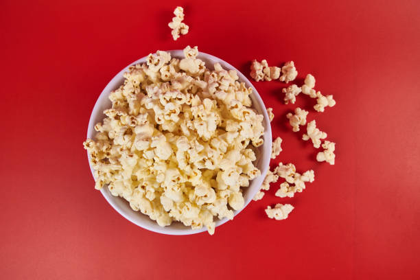 istock Bowl of popcorn on a red background 2177505606
