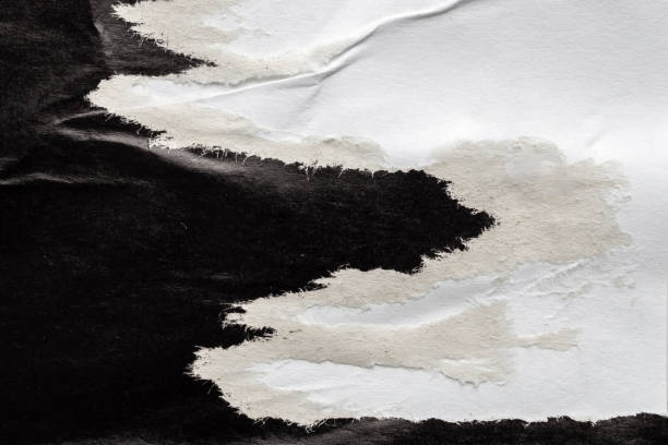 istock Old grunge ripped torn black paper poster surface texture background 2177507873