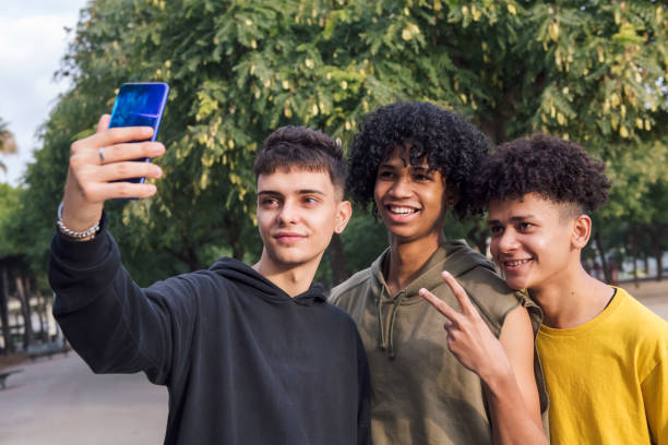 istock three male teens smiling happy taking selfie photo 2177508885