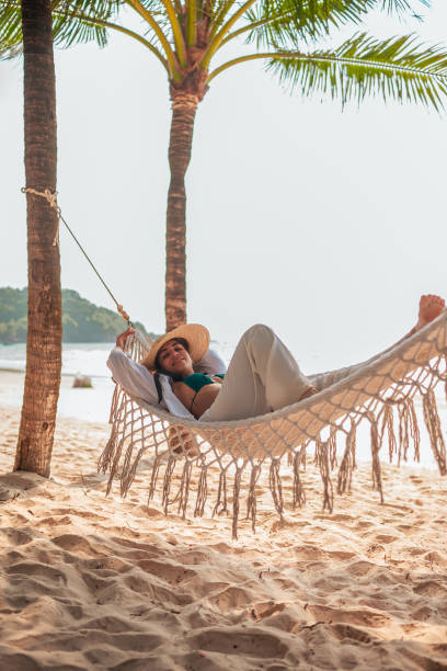 istock Relaxed Hispanic Woman Enjoying Beach Hammock 2177509992