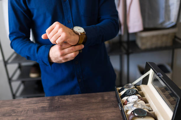 istock Closeup fo a man selecting a wristwatch from a box of displayed timepieces 2177510396