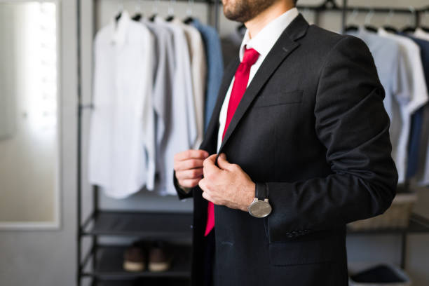 istock Closeup of a businessman buttoning his suit jacket in his dressing room getting ready for work 2177511441