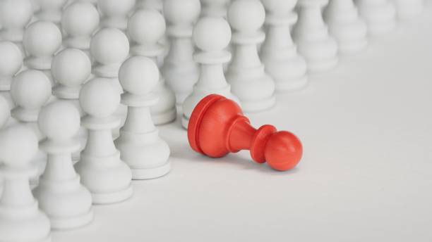 istock 3D illustration of a fallen RED pawn.3D rendering on white background. 2177515322