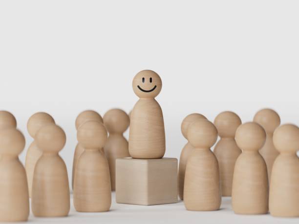 istock Select happy face wooden figure. Customer service rating experience and feedback emotion and satisfaction survey. Human Resources management choosing positive attitude to team leader. 2177516720