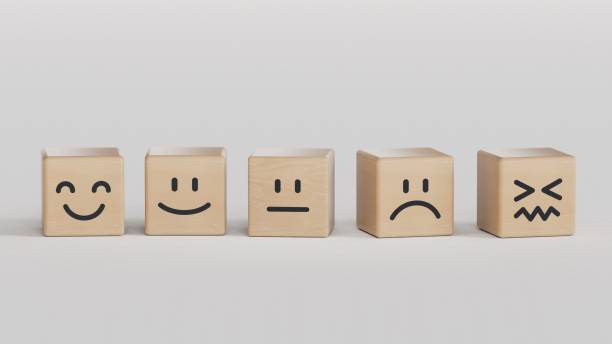 istock Customer service evaluation and satisfaction survey concepts. The client's hand picked the happy face smile face symbol on wooden cube, copy space.3D rendering on black background. 2177517300