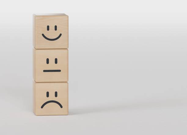 istock Happy, sad and neutral emotion faces on stacking wooden cubes . Customer satisfaction and evaluation concept.3D rendering on black background. 2177517716