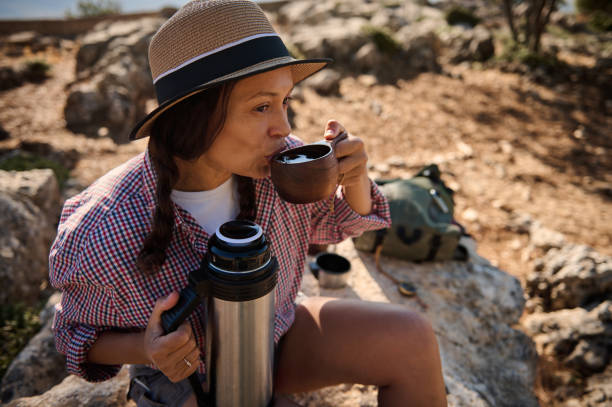 istock Woman enjoying a hot drink outdoors in nature 2177519899