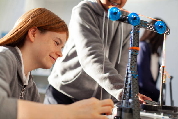 istock Teenage girl in high school classroom making physics construction science engineering technology mathematics STEM project with classmate 2177523271