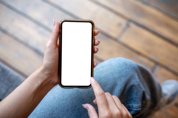 istock A woman's hand holding a smartphone with a white screen mockup while sitting on a terrace. 2177525693