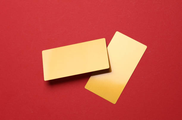 Gold business cards on red background.