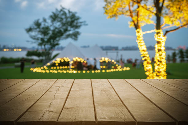 Empty wooden table top with dusk tent camping blurred abstract scenes