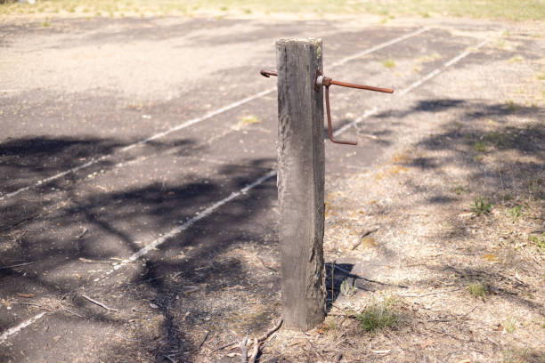 The empty net post of an abandoned tarmac base tennis court in New South Wales, Australia