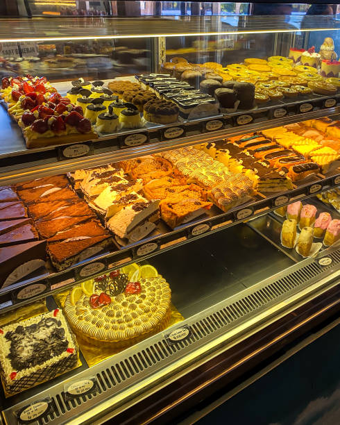 istock Various types of bread on display in a bakery or pastry such as macarons, croissants and danish. Modern bakery with different kinds of Loaf, bread, cakes and buns. 2177538544