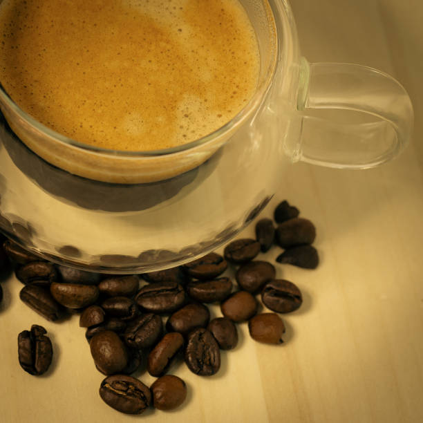 espresso coffee glass cup . coffee cup and roasted coffee beans close up. Macro photo.