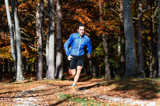 istock Running athlete trains in the autumn forest 2177543666