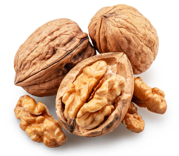 istock Whole walnuts, broken walnut with kernel and green leaves isolated on white background. Clipping path. 2177546375