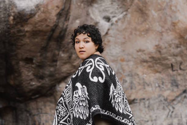 istock Woman in Traditional Poncho Looking Back Against Rock Wall 2177546933